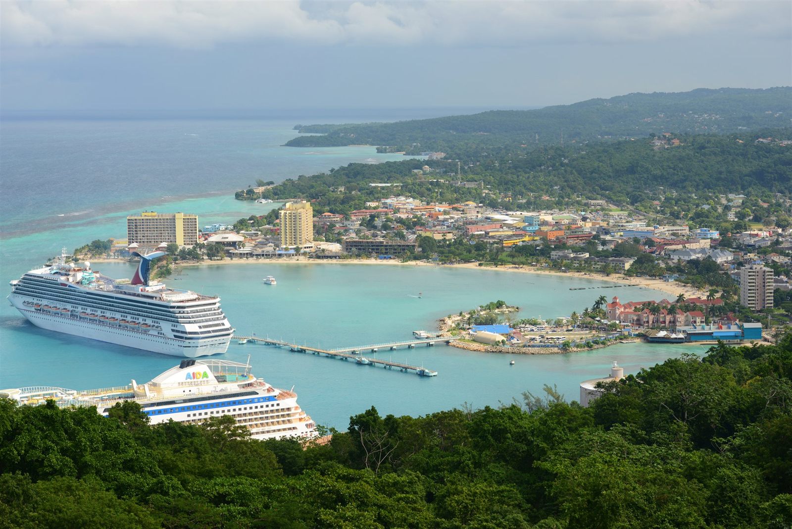 Cruise ships berthed in the bay at Ocho Rios, Jamaica, seen from the green hills above